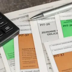 Kalkulator i długopis na dokumentach PIT-28, PIT-36, PIT-37. Czas na rozliczenie roczne, w tym pit-28 ryczałt.