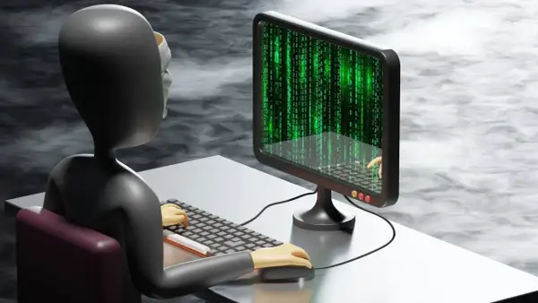 Postać w masce siedzi przy komputerze, na ekranie widać zielony kod. To ilustracja pokazująca, jak działają oszuści kryptowaluty, manipulując danymi.